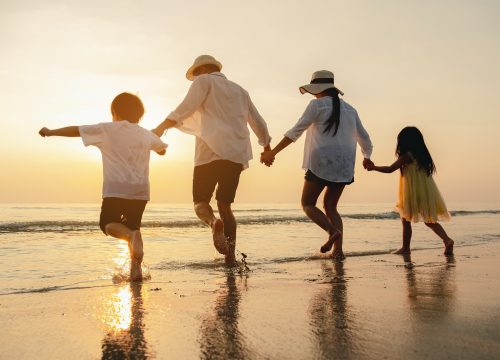 Photo of a family of four at the beach